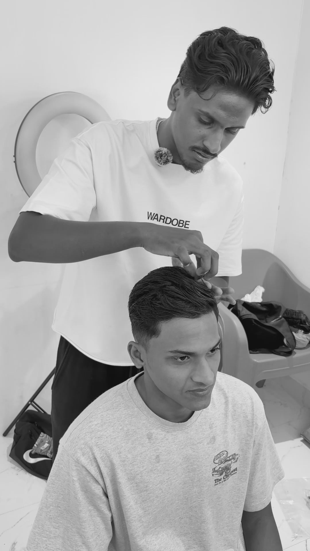 "Behind the scenes of a Wardobe premium menswear photoshoot featuring a model in an oversized white cotton t-shirt."